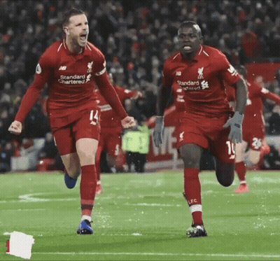 Two Soccer Players In Red Standard Chartered Jerseys GIF
