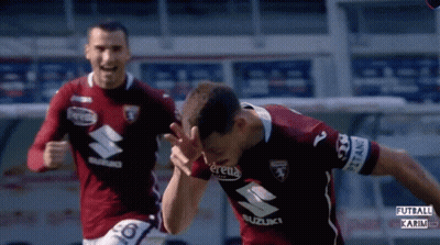 Two Soccer Players In Suzuki Jerseys Running GIF