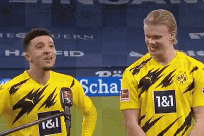Two Soccer Players In Yellow Jerseys Standing On Field GIF