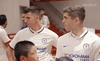Two Soccer Players In Yokohama Tyres Jerseys GIF