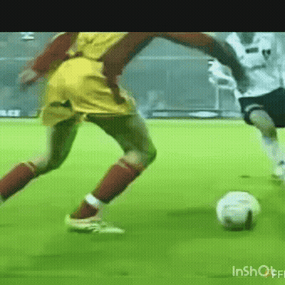 Two Soccer Players Kicking Ball GIF