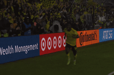 Two Soccer Players Kneeling In Front Of Continental Sign GIF