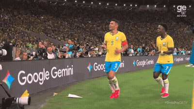 Two Soccer Players On A Field With A Google Gemini Banner GIF