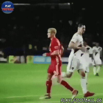Two Soccer Players On A Field With A Play Football Logo In The Background GIF