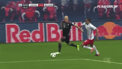 Two Soccer Players On A Field With A Red Bull Ad In The Background GIF