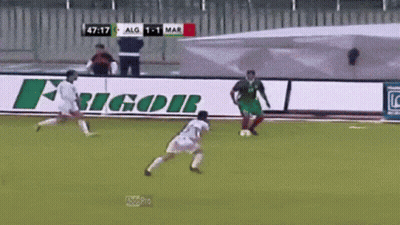Two Soccer Players On A Field With A Sign That Says Ricor On It GIF