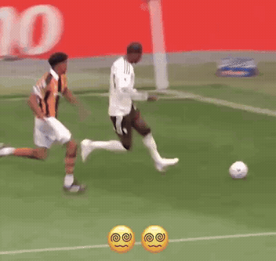 Two Soccer Players On Field With Betano Banner GIF