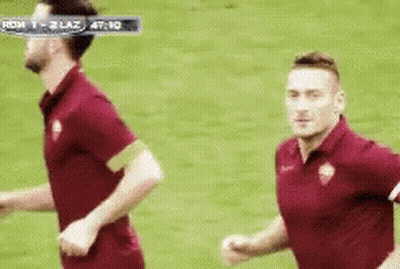Two Soccer Players Running In Roma Vs Lazio Game GIF