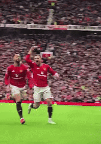 Two Soccer Players Running With Arms Up GIF