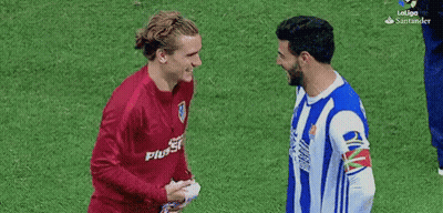 Two Soccer Players Shaking Hands One In Plus500 Shirt GIF