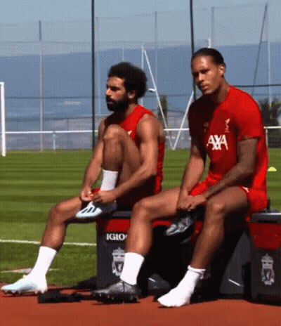 Two Soccer Players Sit On A Cooler That Says Igloo GIF