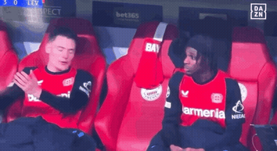 Two Soccer Players Sitting In Stands One With Armenia On Shirt GIF