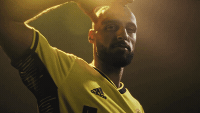 Two Soccer Players Standing Next To Each Other GIF