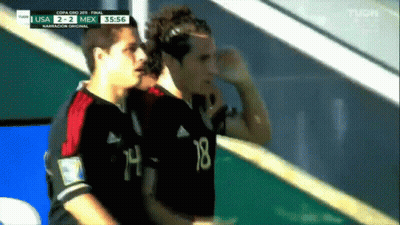 Two Soccer Players Wearing Black Jerseys With The Number 18 On The Back GIF