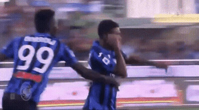 Two Soccer Players Wearing Blue Jerseys With The Number 99 On The Back GIF