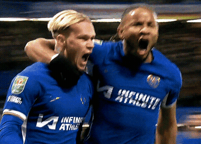 Two Soccer Players Wearing Blue Uniforms That Say Infinity Athlete GIF