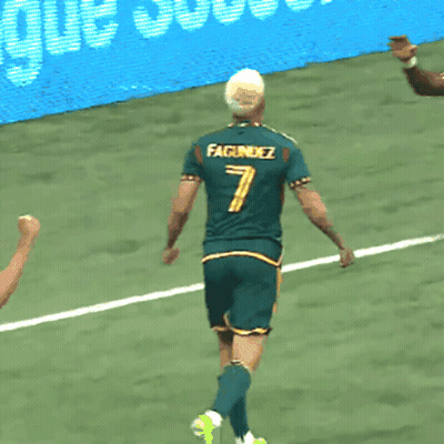 Two Soccer Players Wearing Green Jerseys With The Number 7 And 28 On Them GIF
