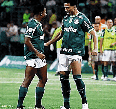 Two Soccer Players Wearing Green Jerseys With The Word Refisa On Them GIF