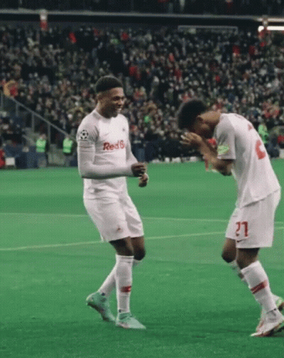 Two Soccer Players Wearing Red 6 Jerseys Celebrate On A Field GIF