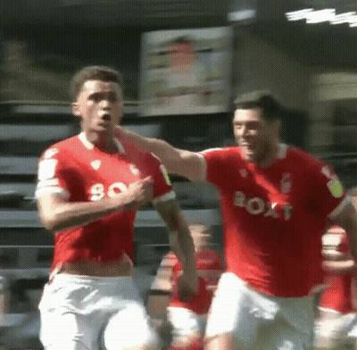 Two Soccer Players Wearing Red Jerseys That Say Boat On Them GIF