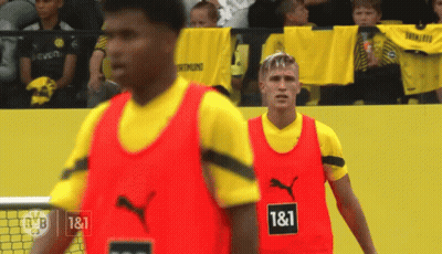 Two Soccer Players Wearing Red Vests With 1 & 1 Written On Them GIF