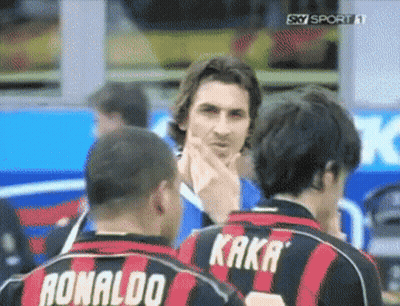two soccer players wearing ronaldo and kaka jerseys are talking to each other