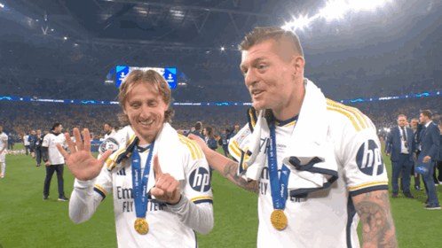 Two Soccer Players Wearing White Shirts With Emirates Fly On The Front GIF