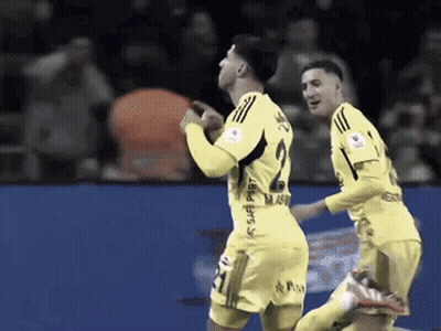 Two Soccer Players Wearing Yellow Jerseys One With The Number 2 On It GIF