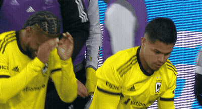 Two Soccer Players Wearing Yellow Jerseys With The Letter B On The Front GIF