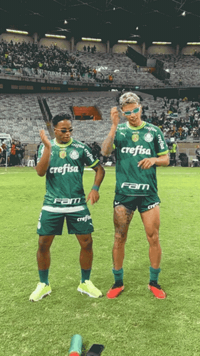 Two Soccer Players With Crefisa On Their Shirts Stand On The Field GIF
