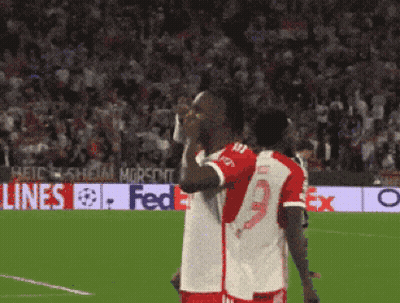 Two Soccer Players With FedEx Banner GIF