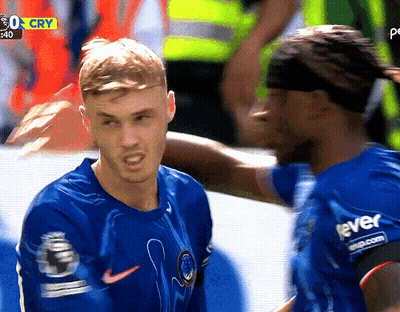 Two Soccer Players With Yellow Sign Saying 0 Cry GIF