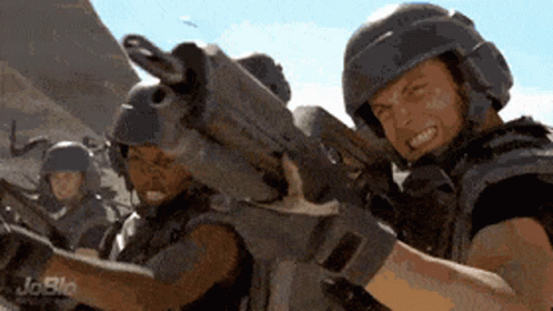 Two Soldiers Are Holding Guns And One Has A Joblo Logo On The Bottom Right GIF