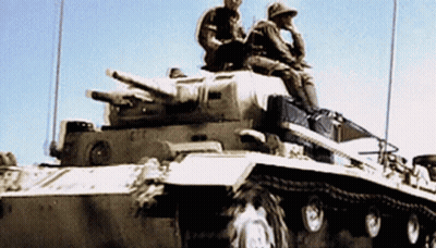 Two Soldiers Are Sitting On Top Of A Tank With A Blue Sky In The Background GIF