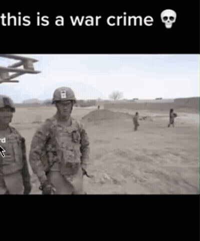 Two Soldiers Are Standing In A Field With The Words This Is A War Crime GIF