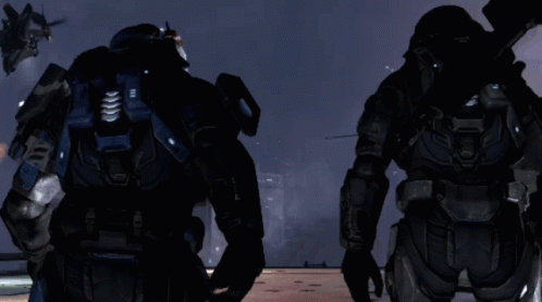 Two Soldiers Are Standing In Front Of A Helicopter With A Message That Says " Move To Ground " On The Screen GIF