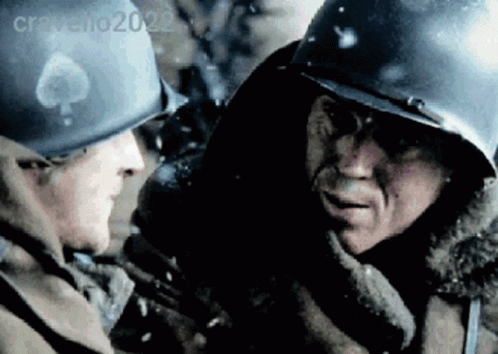 Two Soldiers Wearing Helmets Are Talking To Each Other In A Blurry Photo Taken By Cravello2022 GIF