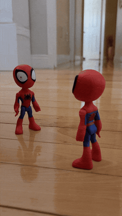 Two Spider Man Action Figures On A Wooden Floor GIF
