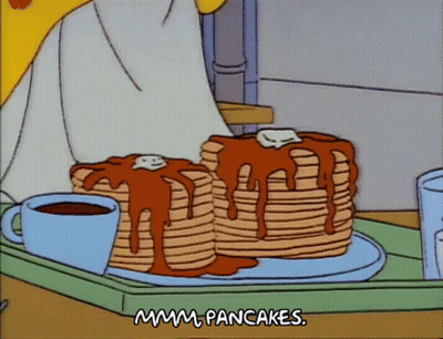 Two Stacks Of Pancakes Are On A Tray With A Cup Of Coffee GIF