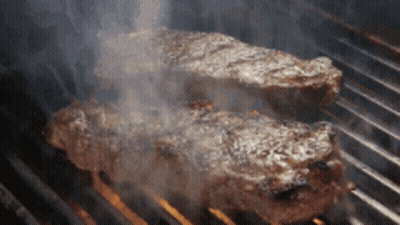 Two Steaks Cooking On Grill GIF