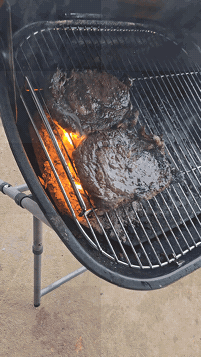 Two Steaks Cooking On Grill With Flames GIF
