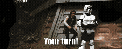 Two Stormtroopers Are Standing Next To Each Other With The Words " Your Turn " Written Below Them GIF