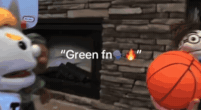 Two Stuffed Animals Are Playing With A Basketball In Front Of A Fireplace That Says " Green Fn " On It GIF