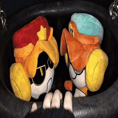 Two Stuffed Animals Are Sitting In A Black Bucket GIF