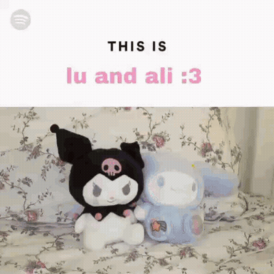 Two Stuffed Animals Are Sitting Next To Each Other On A Bed With Flowers On It . GIF