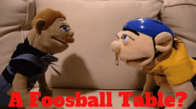 Two Stuffed Animals Are Sitting On A Couch With The Words " A Foosball Table " In Red Letters GIF