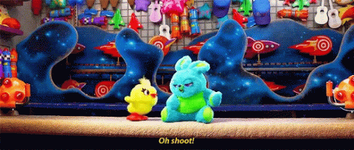 Two Stuffed Animals Are Standing In Front Of A Display Of Rockets And Balloons And One Of Them Says Oh Shoot GIF
