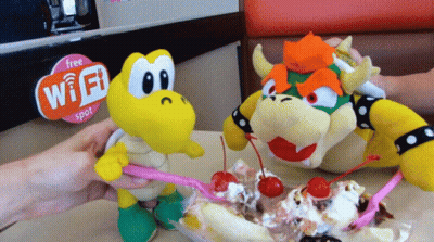 Two Stuffed Animals Eating Ice Cream Next To A Sign That Says Free Wi-Fi Spot GIF