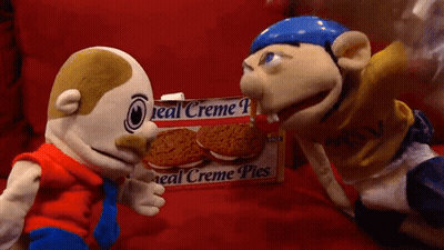 Two Stuffed Animals Next To Box Of Creme Pies GIF