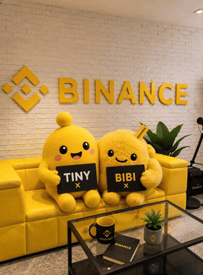 Two Stuffed Animals On Yellow Couch Holding Tiny And Bibi Signs GIF